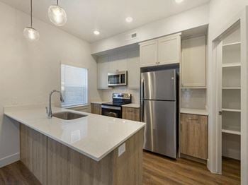 A kitchen with a large island and stainless steel appliances